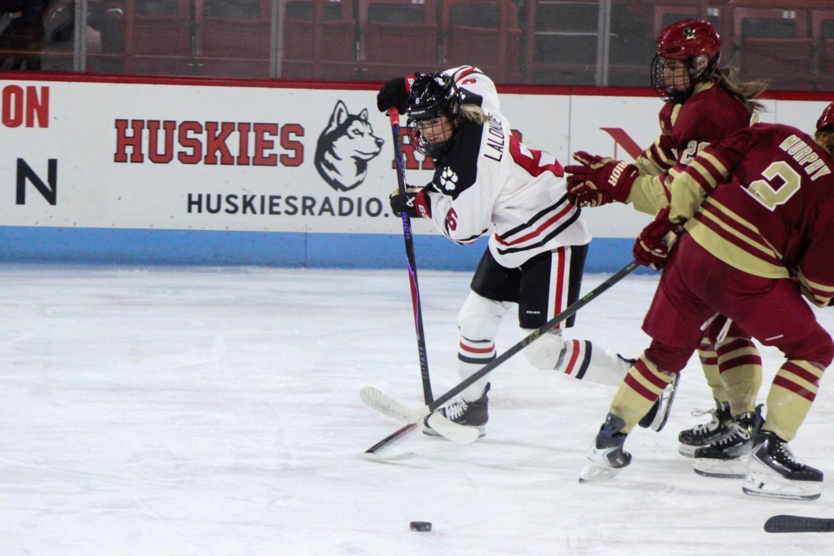 Allie Lalonde fights for the puck. Lalonde scored a hat trick in the 3-1 lead over BC Dec. 5.