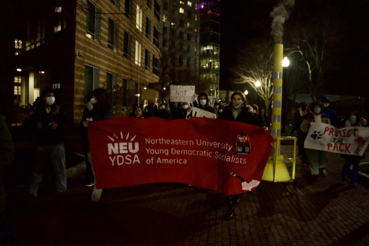 Carrying banners and signs, students march through the West Village quad. YDSA hosted speeches and chanted "Whose campus? Our campus!" and "No fear! No hate! No ICE in our state!" during the rally.