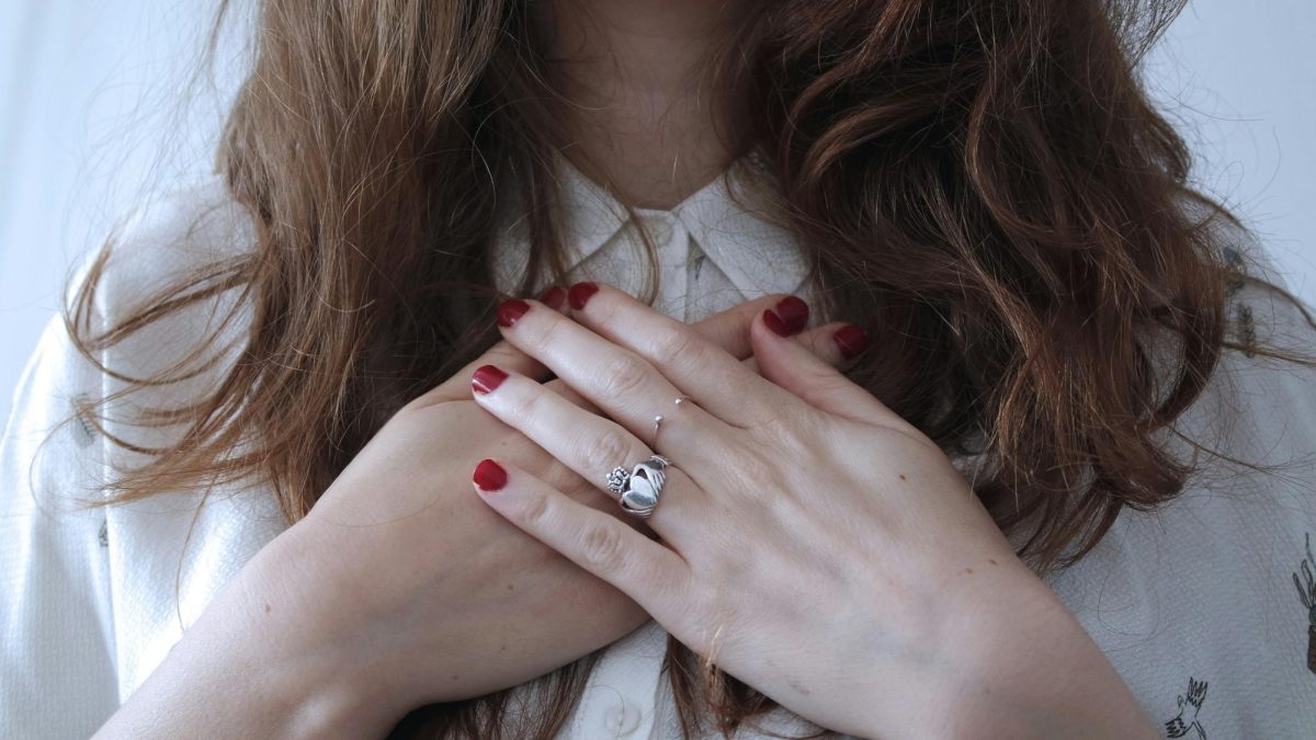 A woman crosses her hands over her heart. People can practice gratitude by meditating, journaling, doing yoga and more. Photo courtesy Giulia Bertelli, Unsplash.