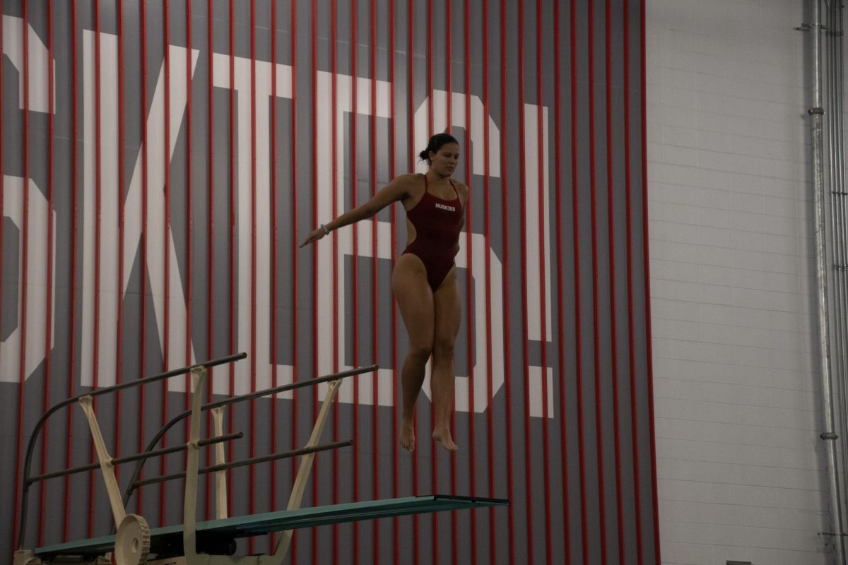 Erin "Kiki" Murphy jumps off the board at an intrasquad meet Sept. 23, 2023. Murphy is one of the most accomplished divers in Northeastern history and is now chasing new goals as part of the rowing team. File photo by Elizabeth Scholl. 