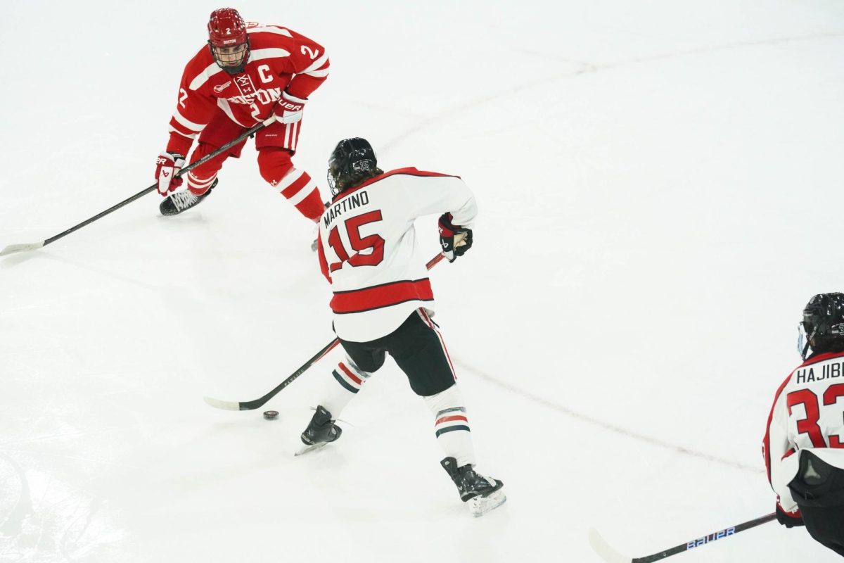 Giacomo Martino takes on a BU defender Dec. 13, 2025. Martino scored the only goal in the Huskies's 4-1 loss Jan. 22.