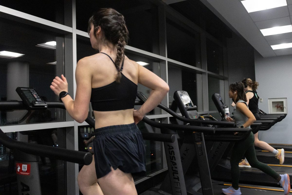 Women run on a treadmill at the Marino Center Jan. 16. Though the societal definition of women's appearances has changed since the 1950s, women still face stigma about body standards today.