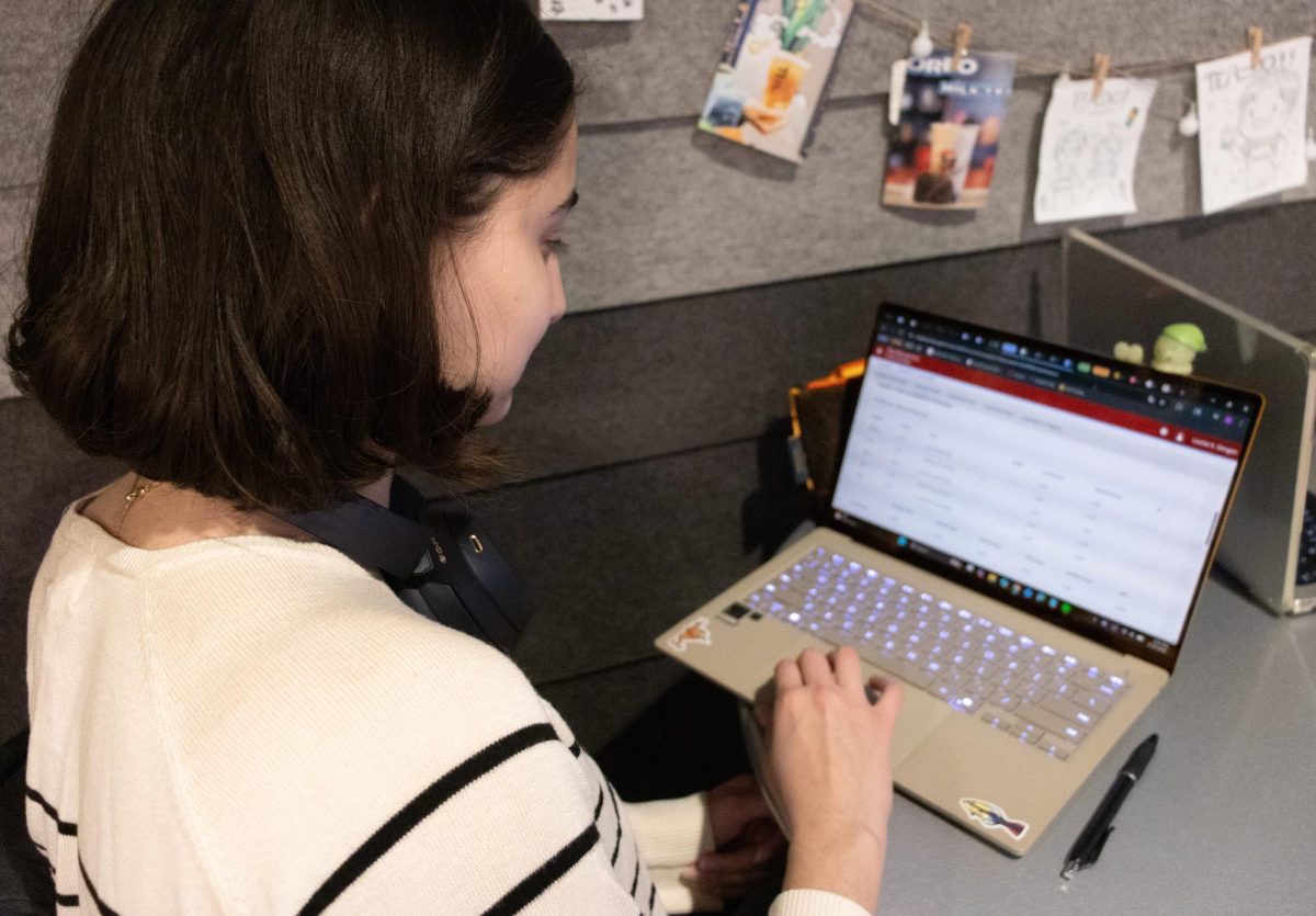 A student reviews their grades. The college GPA median increased 21.5% from 1990 to 2020, raising concerns about Northeastern’s approach to grade inflation.