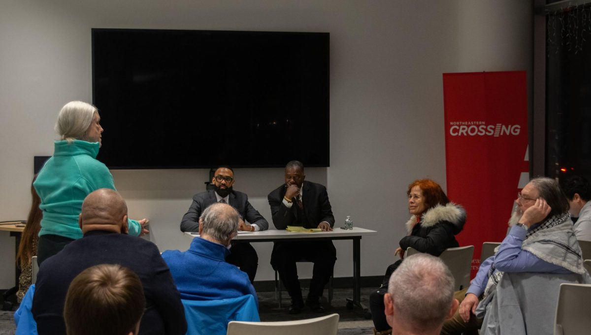 Miniard Culpepper (right) listens intently to a resident voicing her concerns and ideas Feb. 5. Attendees addressed several issues, including drug abuse and affordable housing, during the two hour meeting.