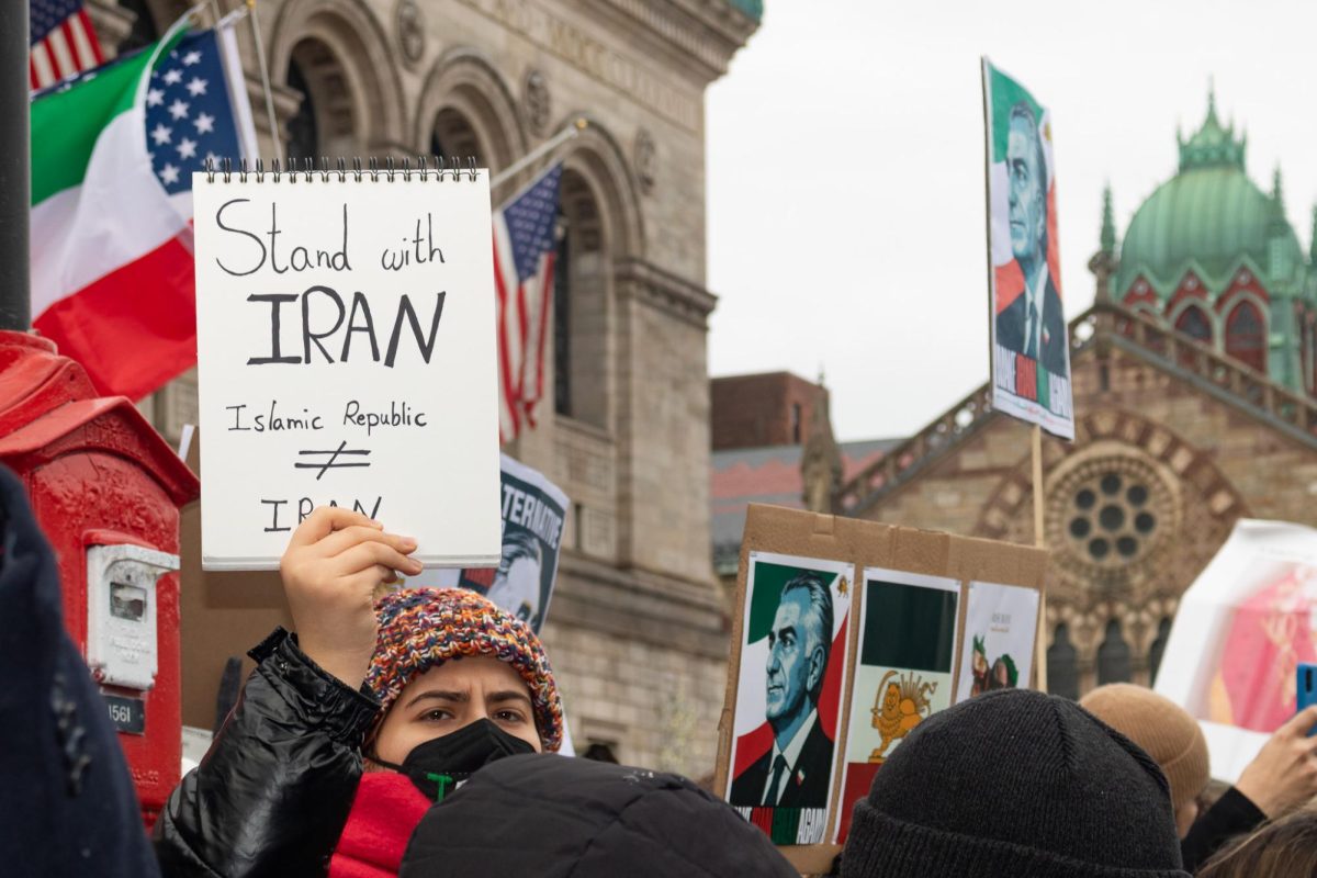 A demonstrator holds up a sign advocating for community solidarity with the Iranian people during a protest in Copley Square Feb. 14. Mass protests against the Islamic Republic government erupted across Iran throughout January, marking it as the largest uprising in Iran since 1979.