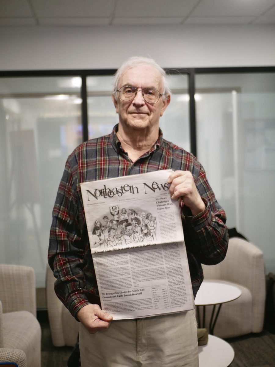 Rothstein poses with a 50th anniversary edition of The Northeastern News.
News alumni reunited to write and
design the special edition together.