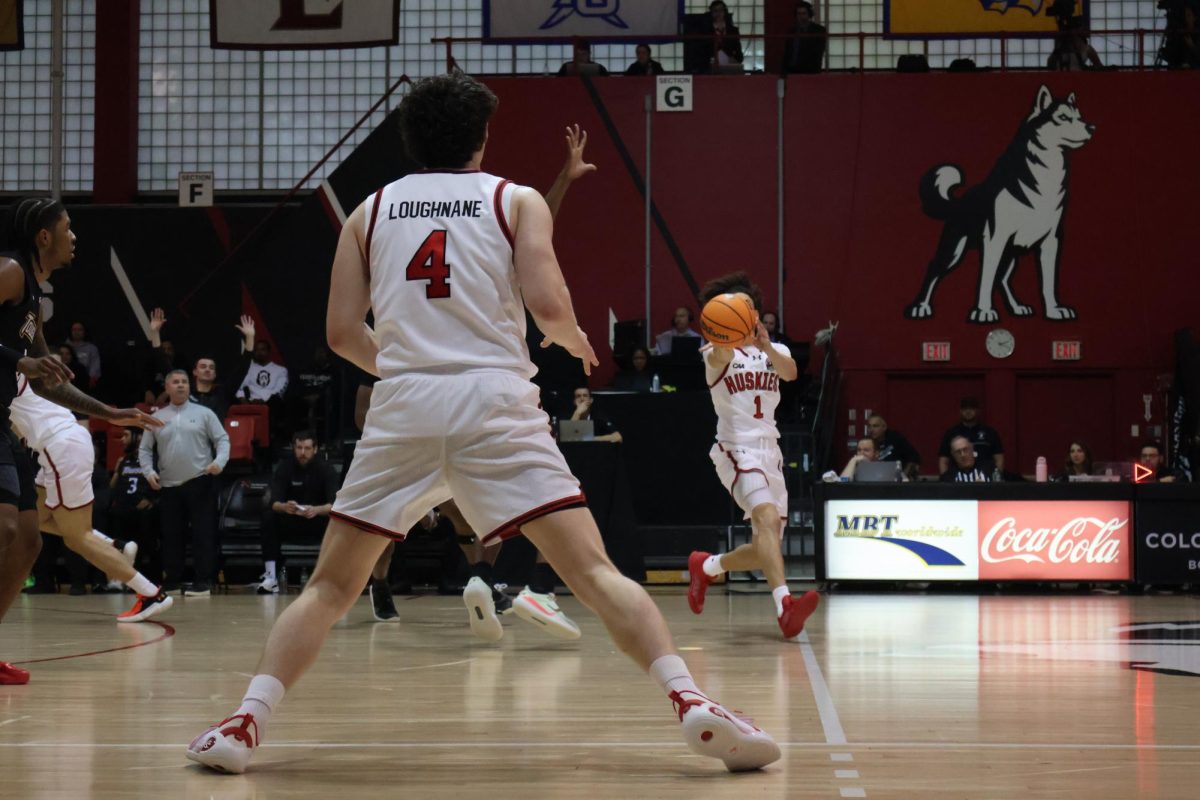 Junior guard Mike Loughnane receives a pass from freshman guard Xavier Abreu Jan. 10. Loughnane scored 17 points, the most for the Huskies in the 69-55 loss against Stony Brook Feb. 7.