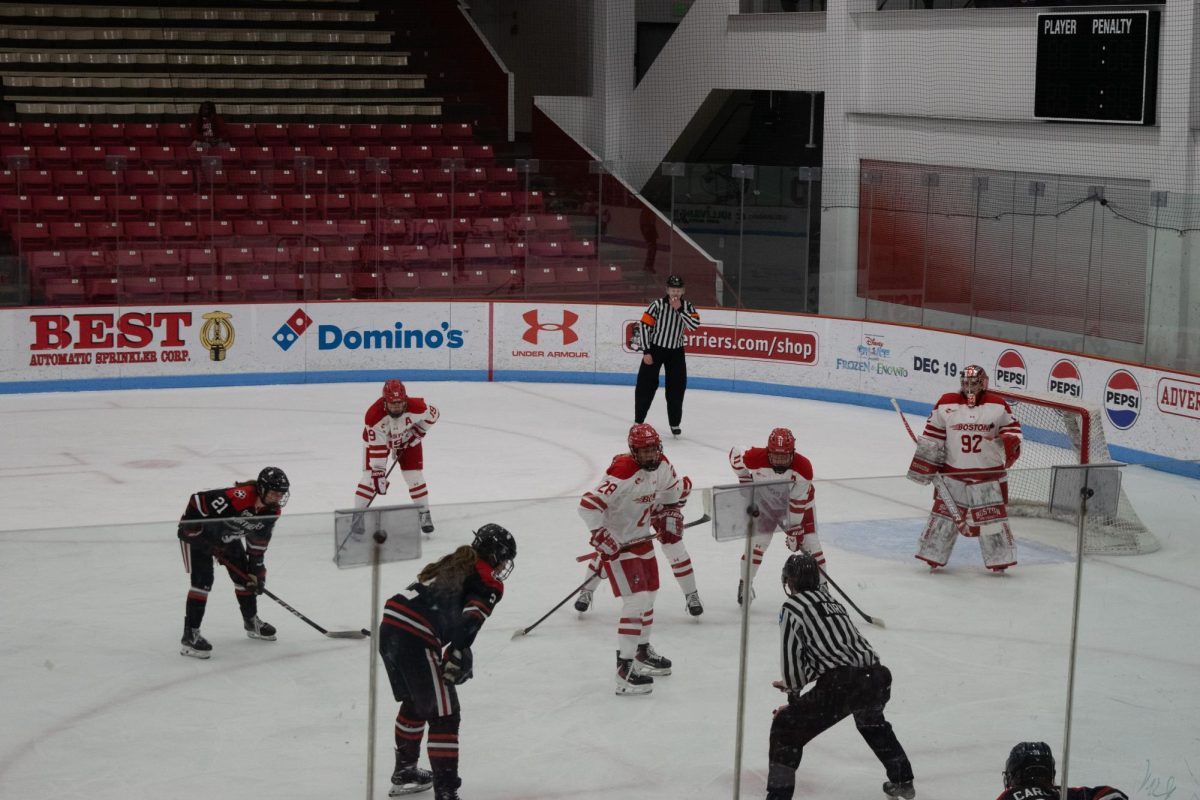 Senior forward and captain Lily Shannon (bottom left) prepares to faceoff against her opponent. The Huskies defeated the Terriers 5-2 Feb. 13.