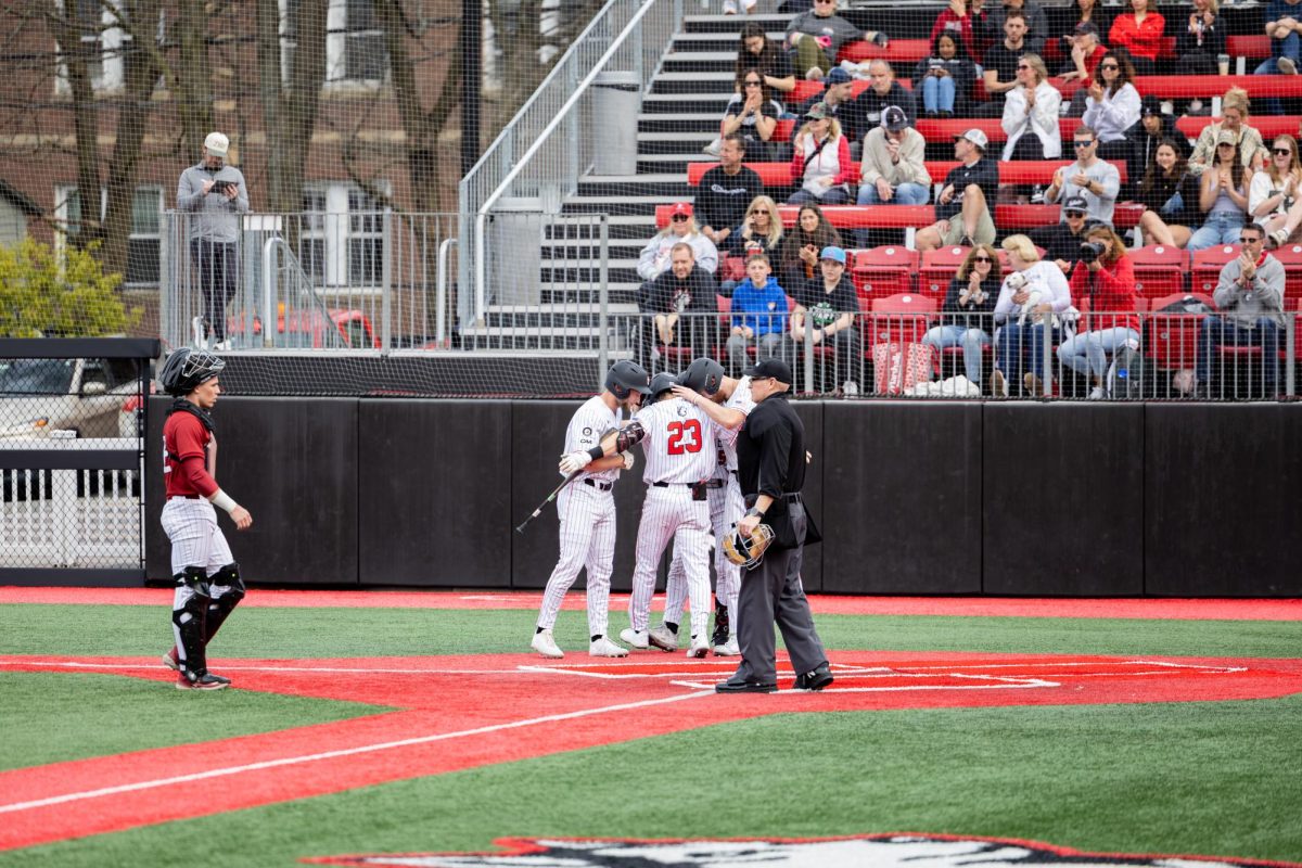 Northeastern huddles at home plate March 16, 2025. Northeastern won three of its four games in Louisana Feb. 27 to March 2.