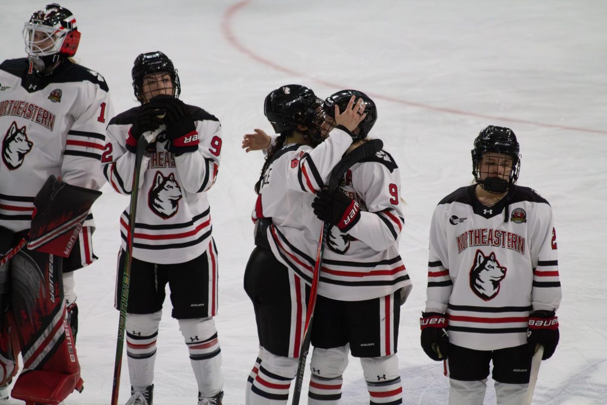 Huskies console each other after the loss March 7. This defeat marked the third consecutive year Northeastern lost the Hockey East championships.