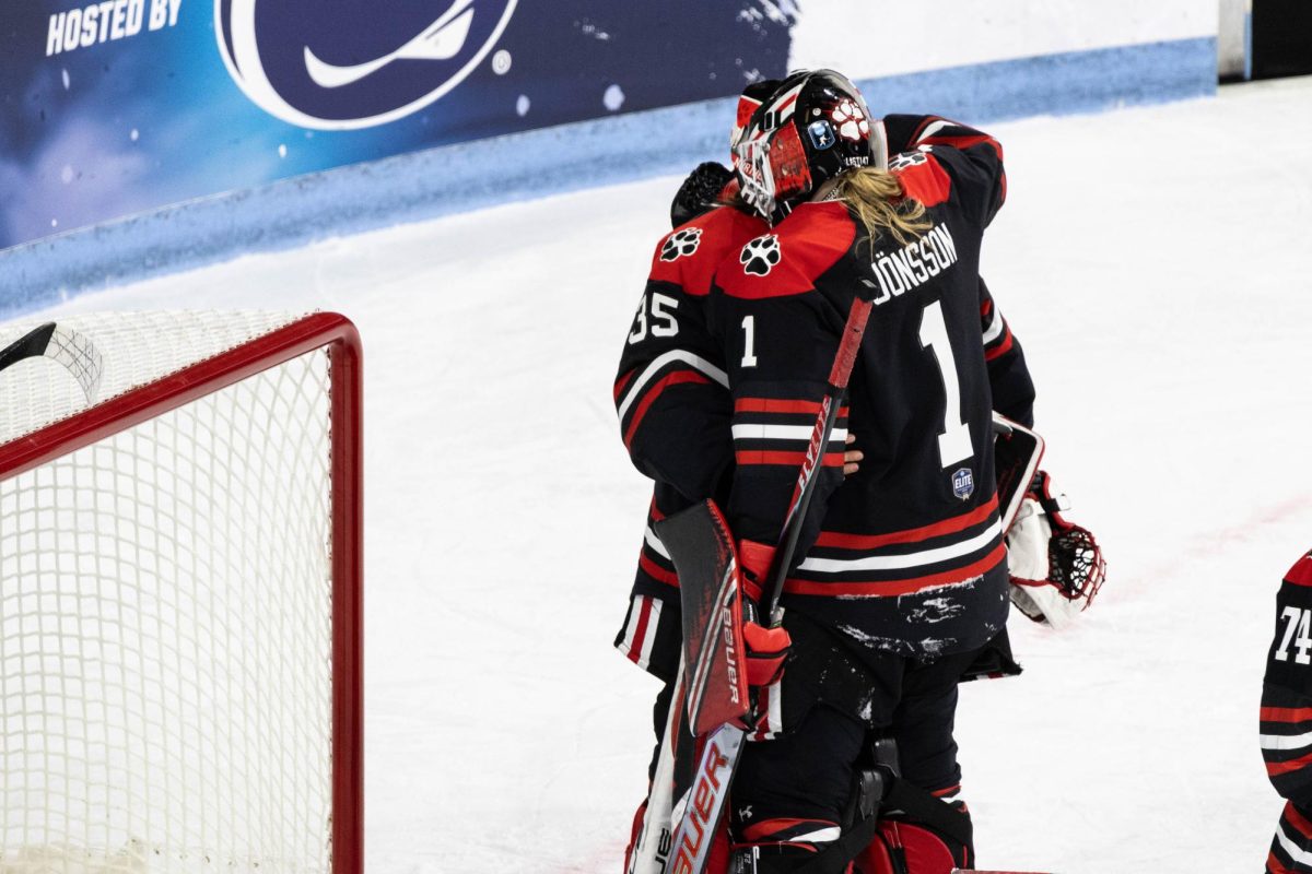 Sophomore goaltender Lisa Jönsson (right) hugs fifth-year goaltender Paige Taborski after losing 5-0 to Ohio State University in the NCAA Frozen Four. This was the final game for many pivotal players such as Taborski, Shannon and Constantinople.