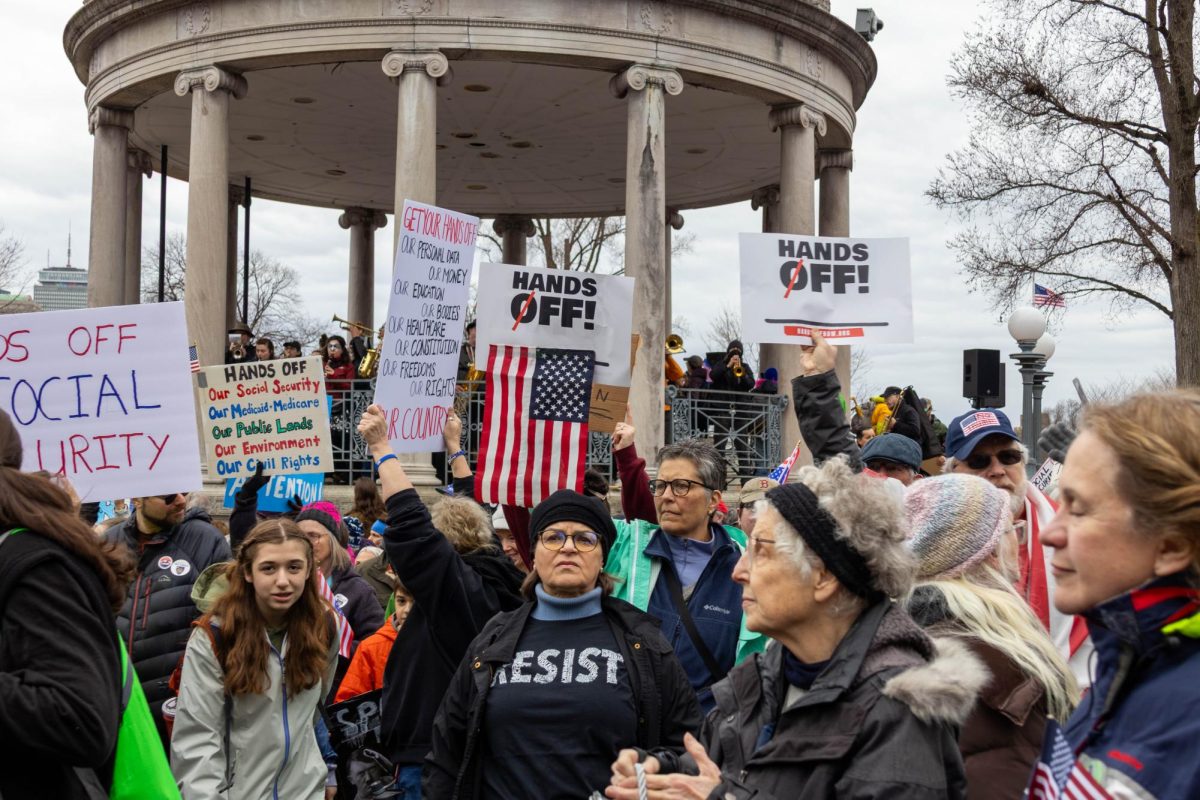 Protesters stand in front of the Parkman Bandstand during the “Hands Off” rally April 5, 2025. Many pieces of architecture and statues were added to the public park to honor historical figures and events. 