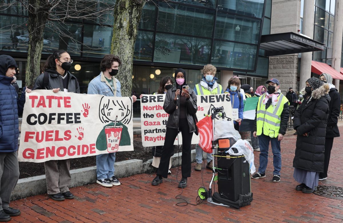 A student protester gives a speech in front of Tatte during a Huskies for a Free Palestine protest March 23. The organization urged Northeastern to divest from Raytheon and urged students to boycott against Tatte.
