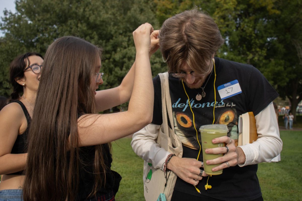 A friend helps fourth-year Emmanuel College student Jack Davis fix his hair before the Performative Person contest in Boston Common Sept. 27, 2025. Social media platforms popularized the term "performative male" in mid-2025.