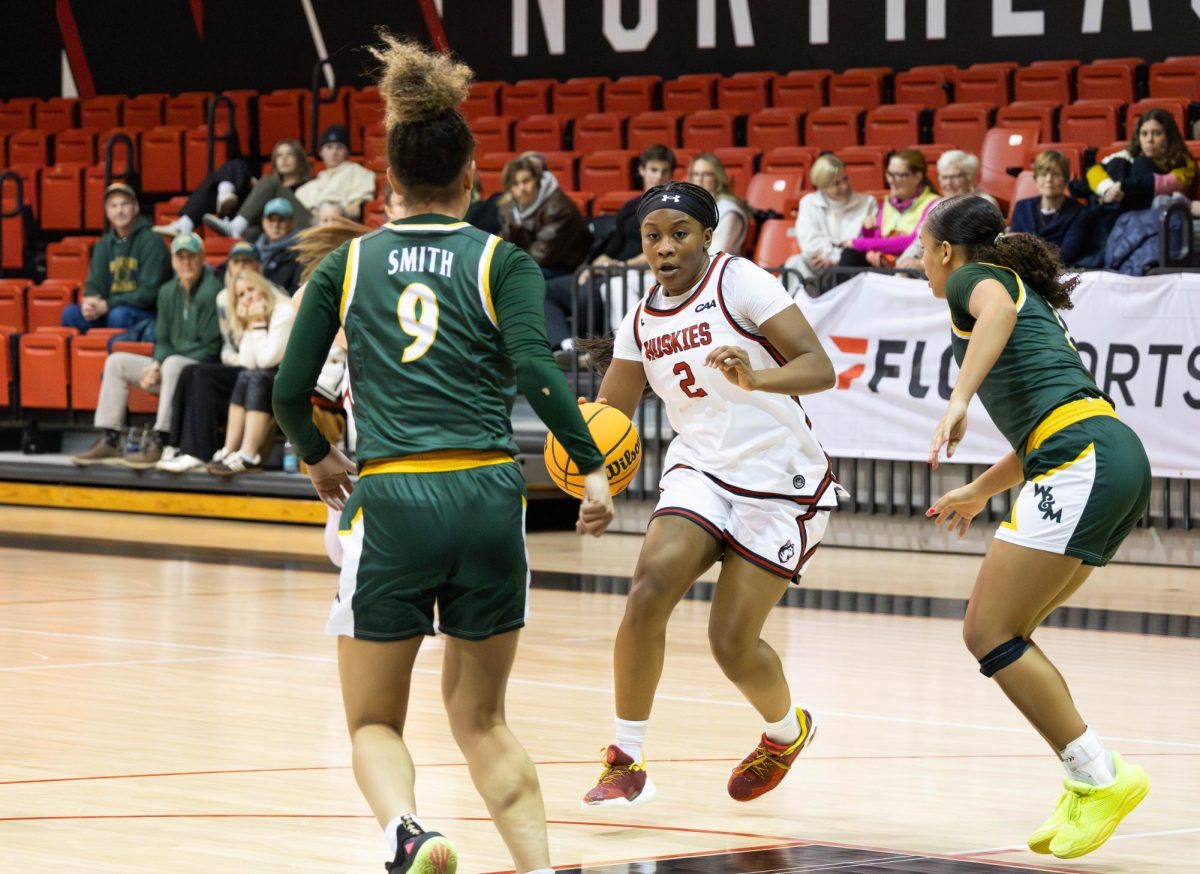 Sophomore guard Camryn Collins drives towards William & Mary defense in a game Jan. 23. Collins led the Huskies in scoring with 15 points after returning from a head injury.