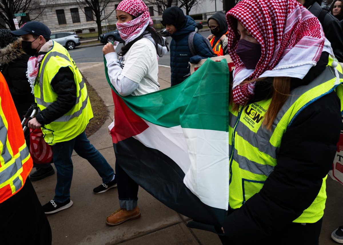 Two protesters carry a Palestinian flag during the Huskies for a Free Palestine protest March 23. Read more here.
