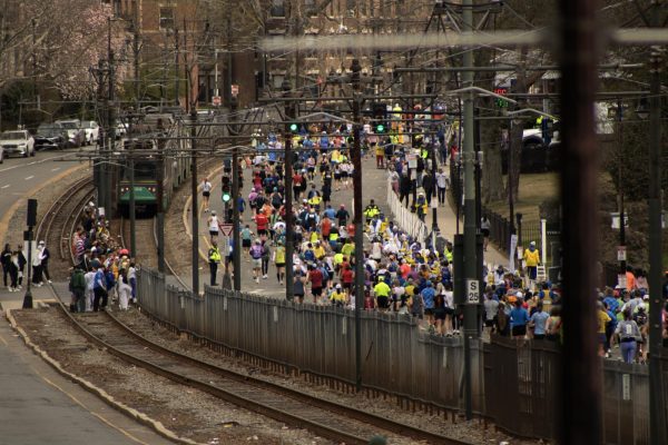 Marathoners round the corner on Commonwealth Avenue while attempting the notorious Heartbreak Hill April 20. Spectators took the opportunity to watch the racers from the barriers, empty train tracks and even while riding the Green Line.