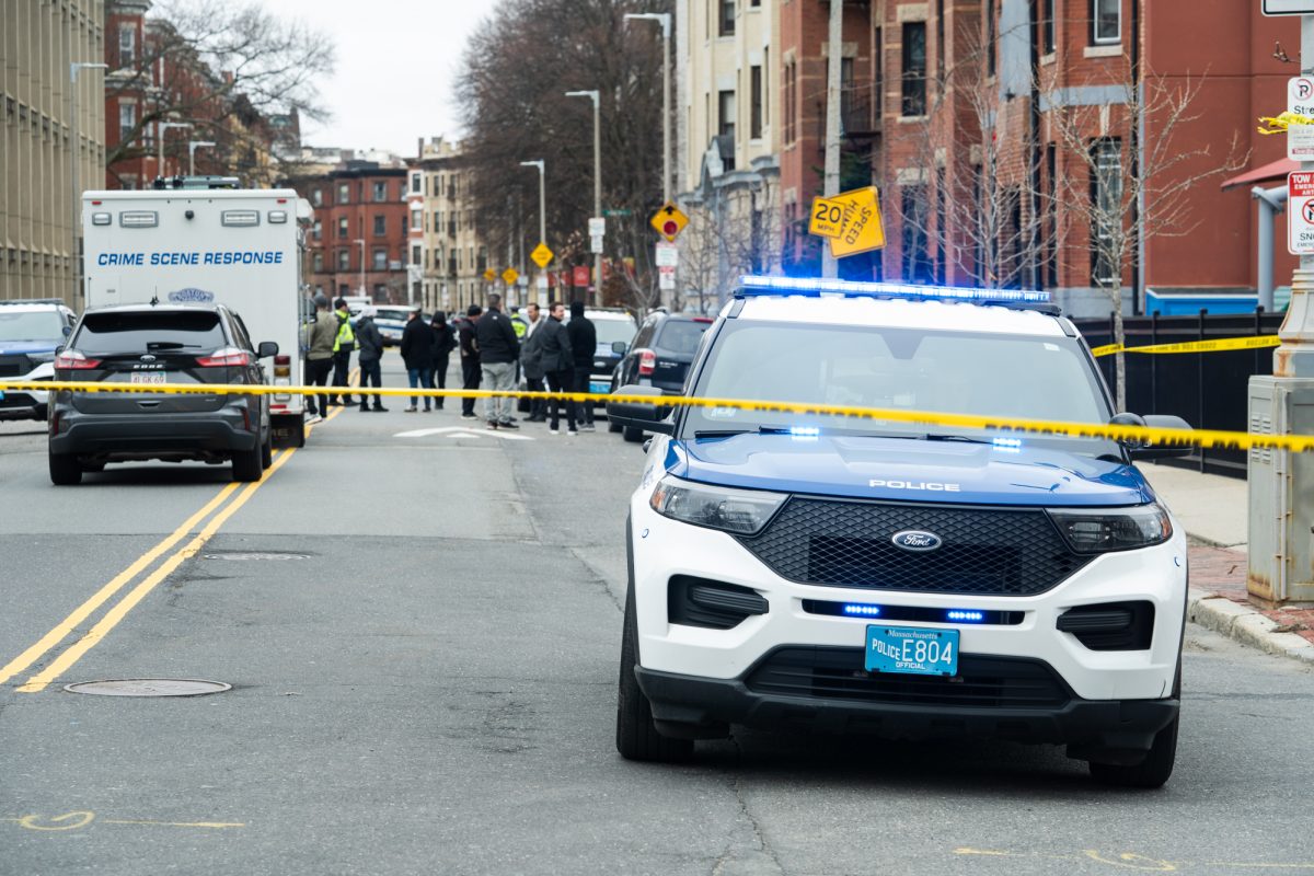 BPD police officers, a crime response team and emergency vehicles gather outside of 212 Hemenway St. after a shooting April 4. The Clery Act required university and college administrations to publicly report campus crime data, support victims of violence and outline the policies since 1990.
