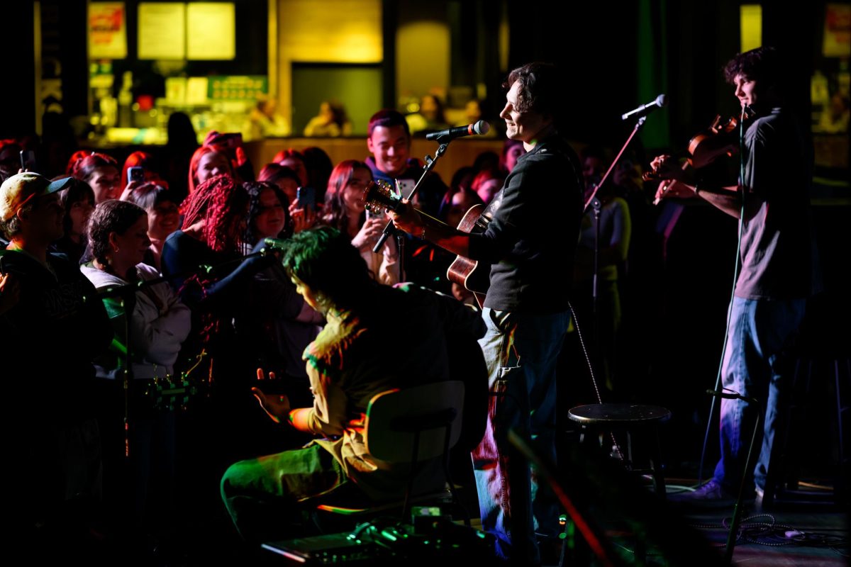 Jake Minch (center) and accompanying musicians Liam Creamer (left) and Jonah Kreitner perform to the crowd in AfterHours April 8. Minch rose to fame by posting his music on TikTok.