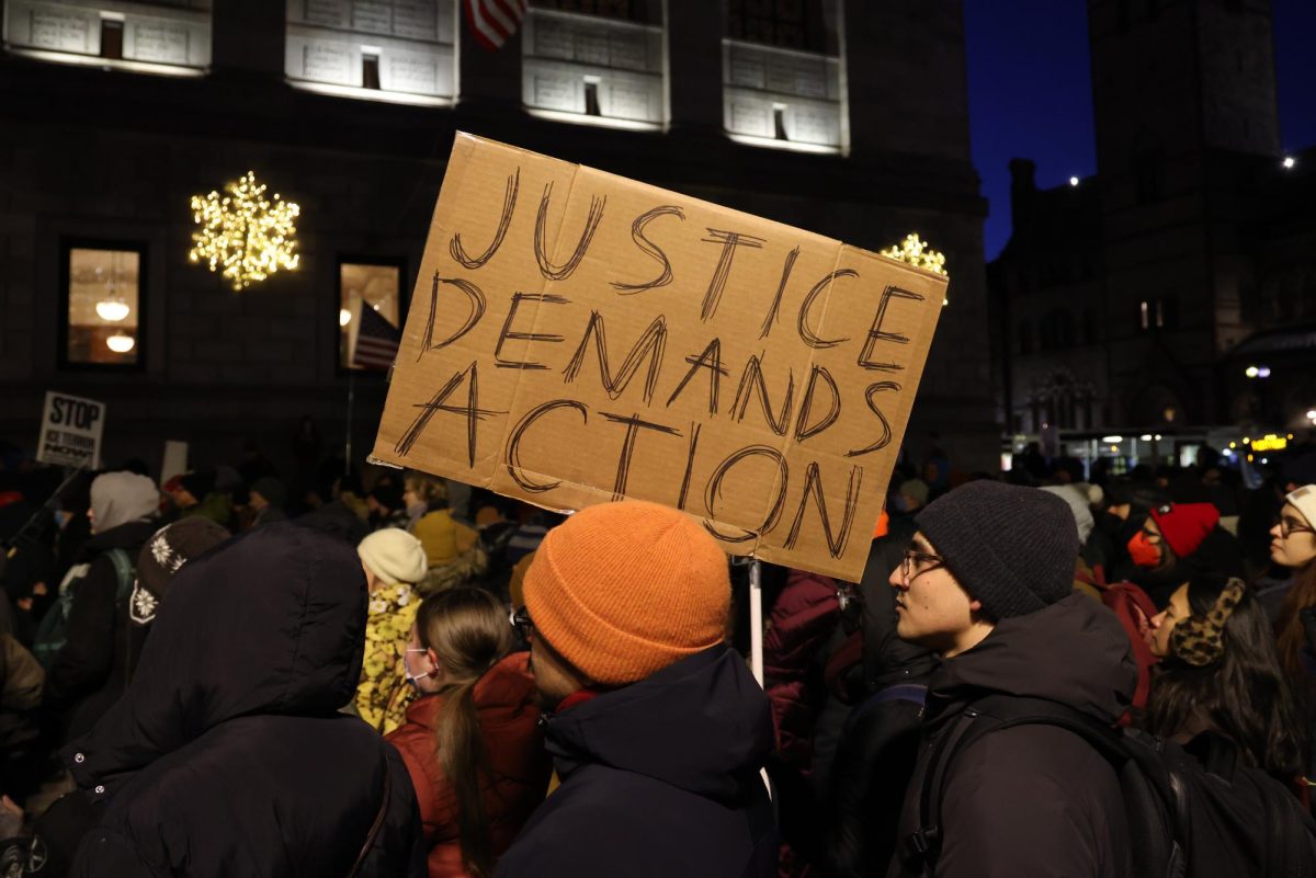 A protester holds a sign reading, "Justice demands action" during the "Stop ICE Terror" protest Jan. 20. Protests are one of the most effective methods of enacting political change, according to American Psychological Association.