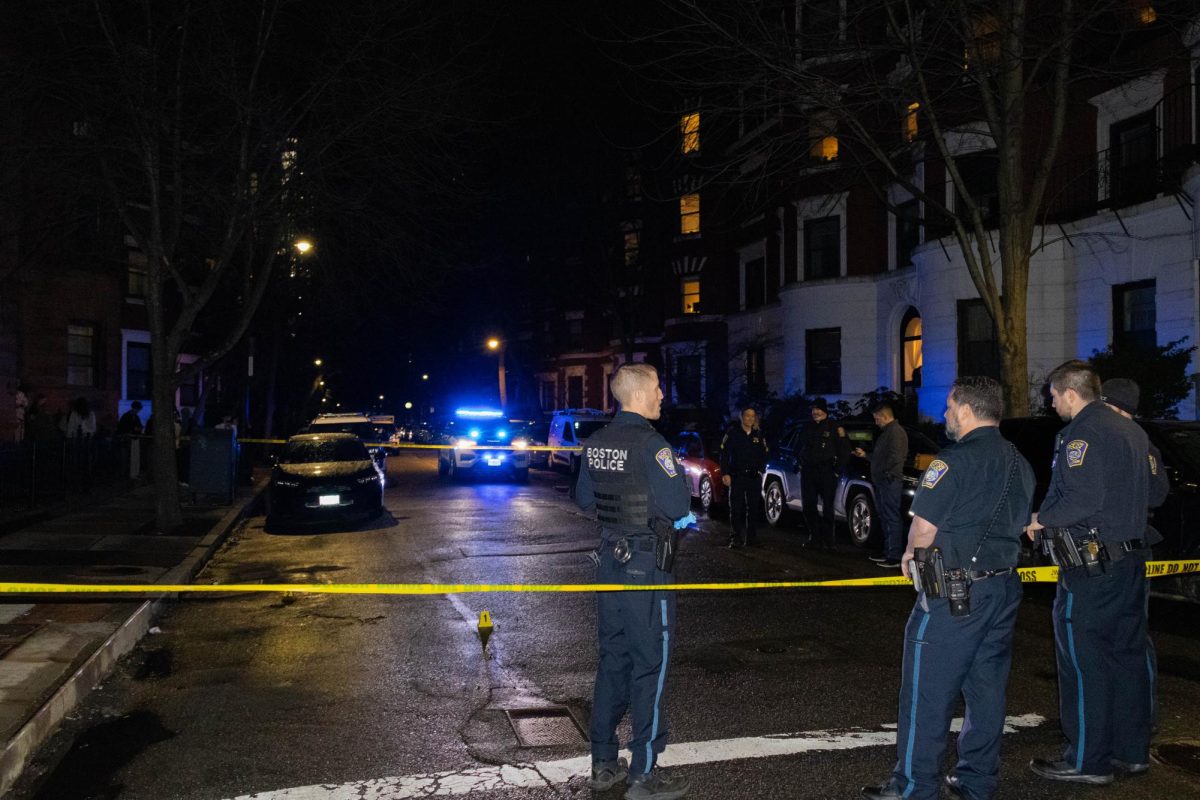BPD police officers, vehicles and caution tape block off an area at the Gainsborough and Hemenway streets intersection April 1. Gun shots were heard in the area around 10:06 p.m., resulting in an investigation and public safety alerts to Berklee College of Music students.