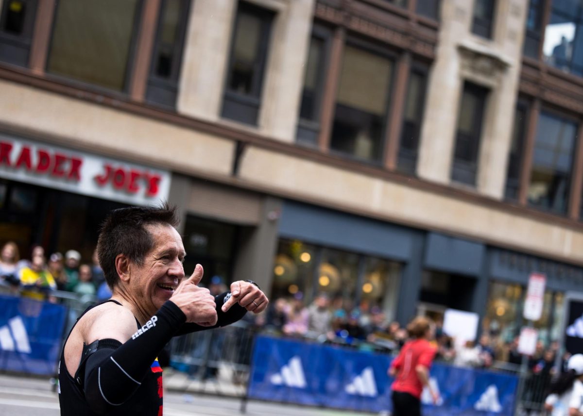 A runner gestures to the crowd as he approaches the finish area on Boylston Street during the Boston Marathon April 20. Read more herehere.