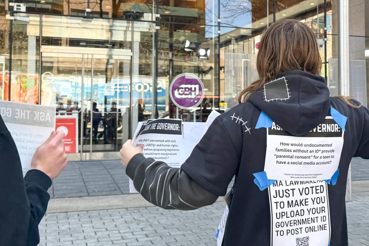 Protesters hold signage asking Healey to listen to LGBTQ youth and communities after passing a bill April 28. The bill prohibited children under 14 from creating social media accounts.