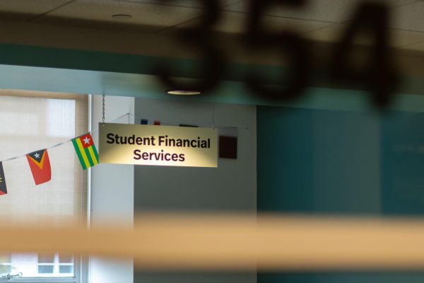 The interior of the Student Financial Services offices framed by the external window and room number April 25, 2025. The New York Times published a column about Northeastern University's inefficiency in resolving financial appeals April 28.