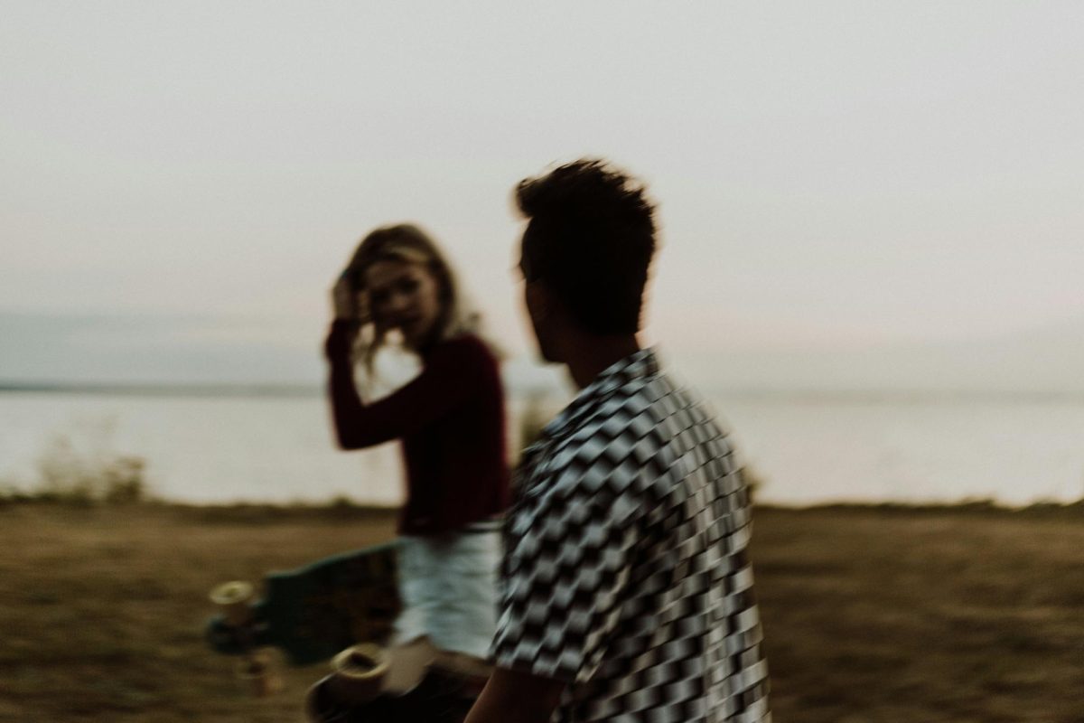 A woman and man walk by a lake while surrounded by grassy terrain. Maintaining fulfilling friendships reduces risk of depression and improves life satisfaction according to the American Psychological Association. Photo courtesy y Priscilla Du Preez, Unsplash.